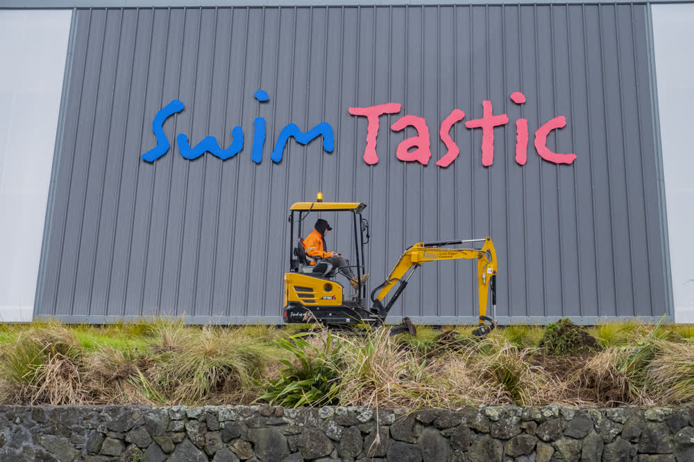 Digger work on planting and retaining wall at Swimtastic